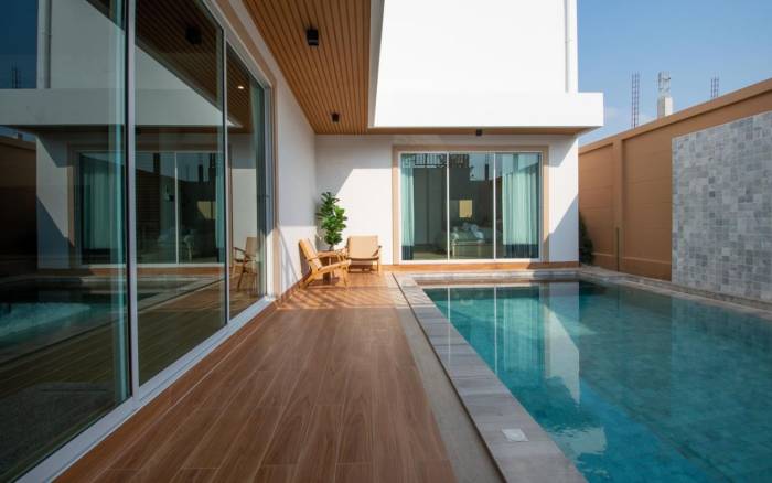 Narita Villa exterior street view with a modern facade, covered garage, and rooftop terrace.