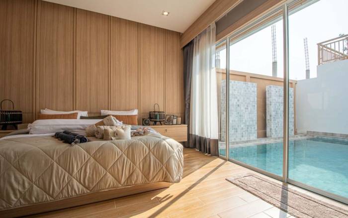 Narita Villa outdoor patio with a private swimming pool, lounge chairs, and sliding glass doors.