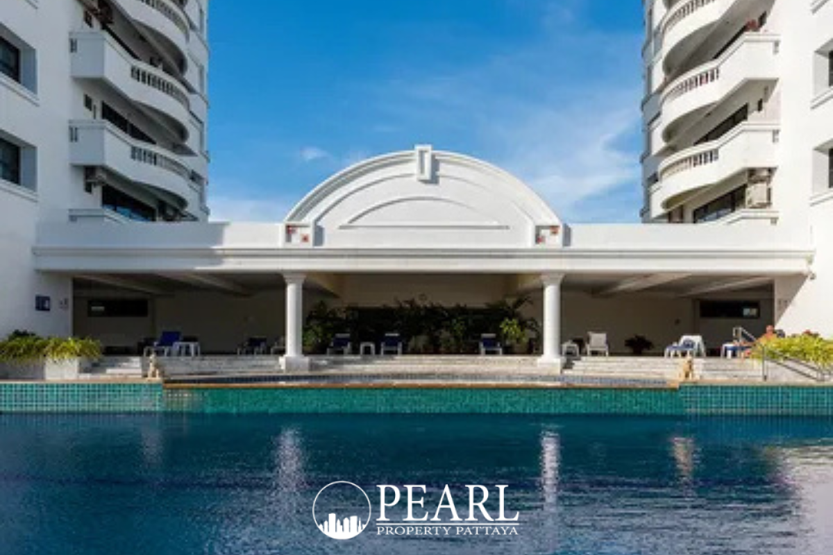 Jomtien Complex: Two tall, white residential towers with balconies against a blue sky, seen from a low angle.