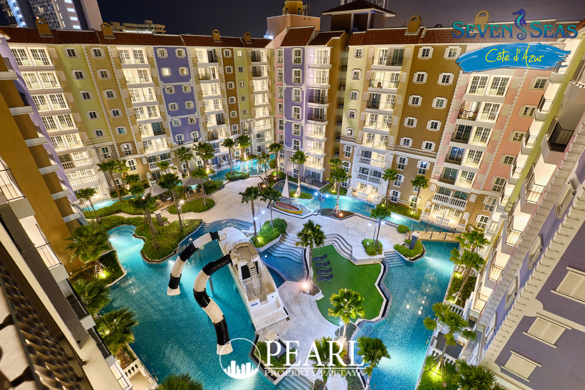 Seven Seas Cote d'Azur: Aerial view of the large lagoon-style swimming pool, surrounding buildings, and central courtyard at night.