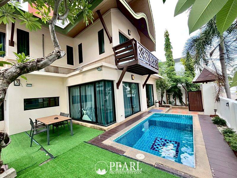 Baan Natcha Village entrance gate with traditional Thai-style guardhouse and security barrier.