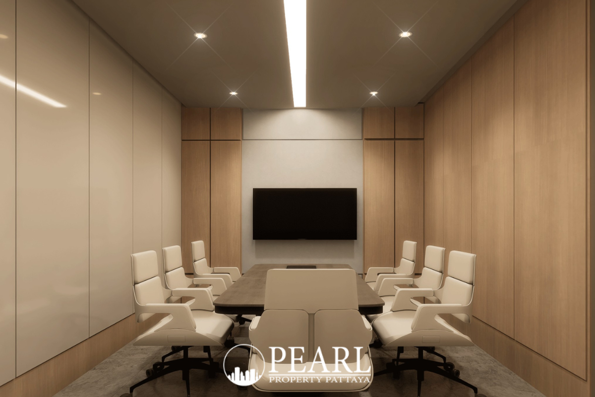 Baan Mae 12 – Onyx Grand Village modern conference room with a large table, white chairs, and wall-mounted TV.