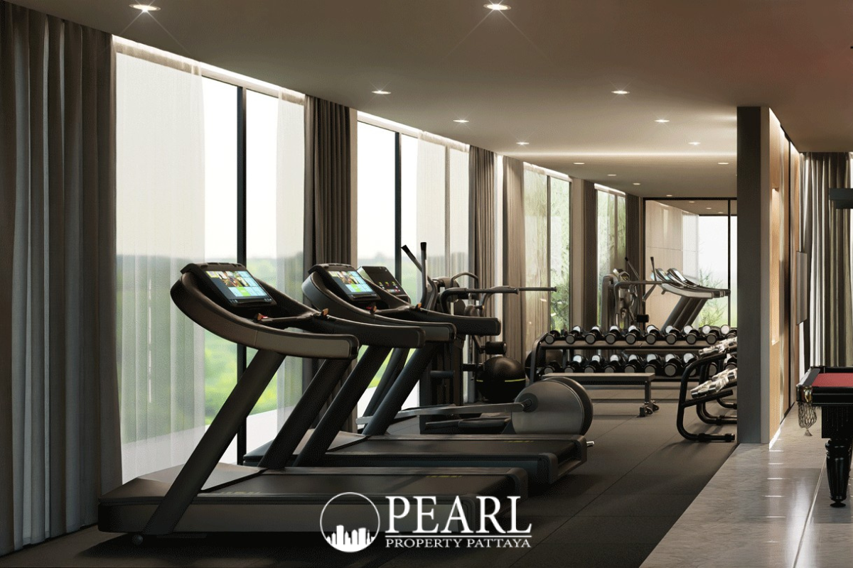 Baan Mae 12 – Onyx Grand Village fitness area with treadmills, weight rack, and large windows.