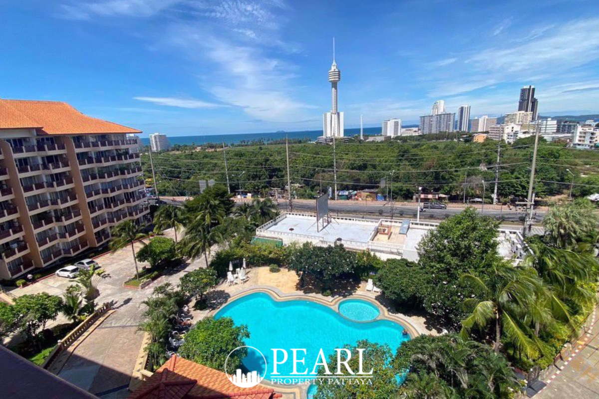 Royal Hill Resort main entrance and large outdoor swimming pool with sun loungers, surrounded by tropical plants.