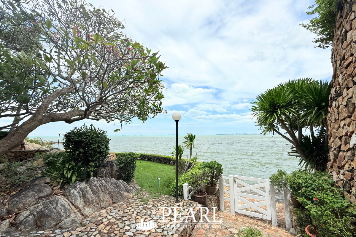 Garden Cliff Condominium 1 exterior view of the multi-story building with balconies and lush landscaping.