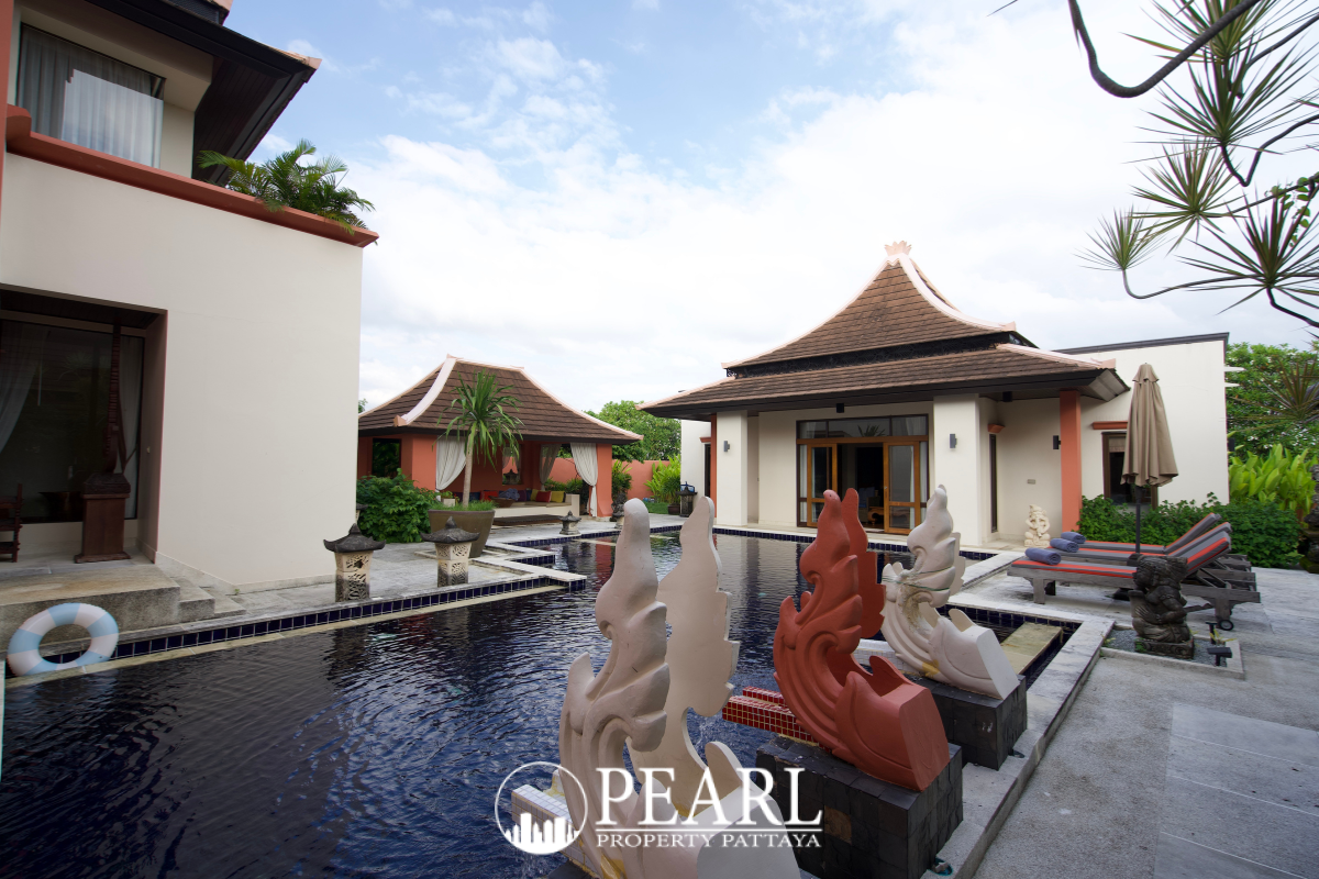 Phutara exterior of a house with traditional Thai roof, private entrance, and garage with dark gate.